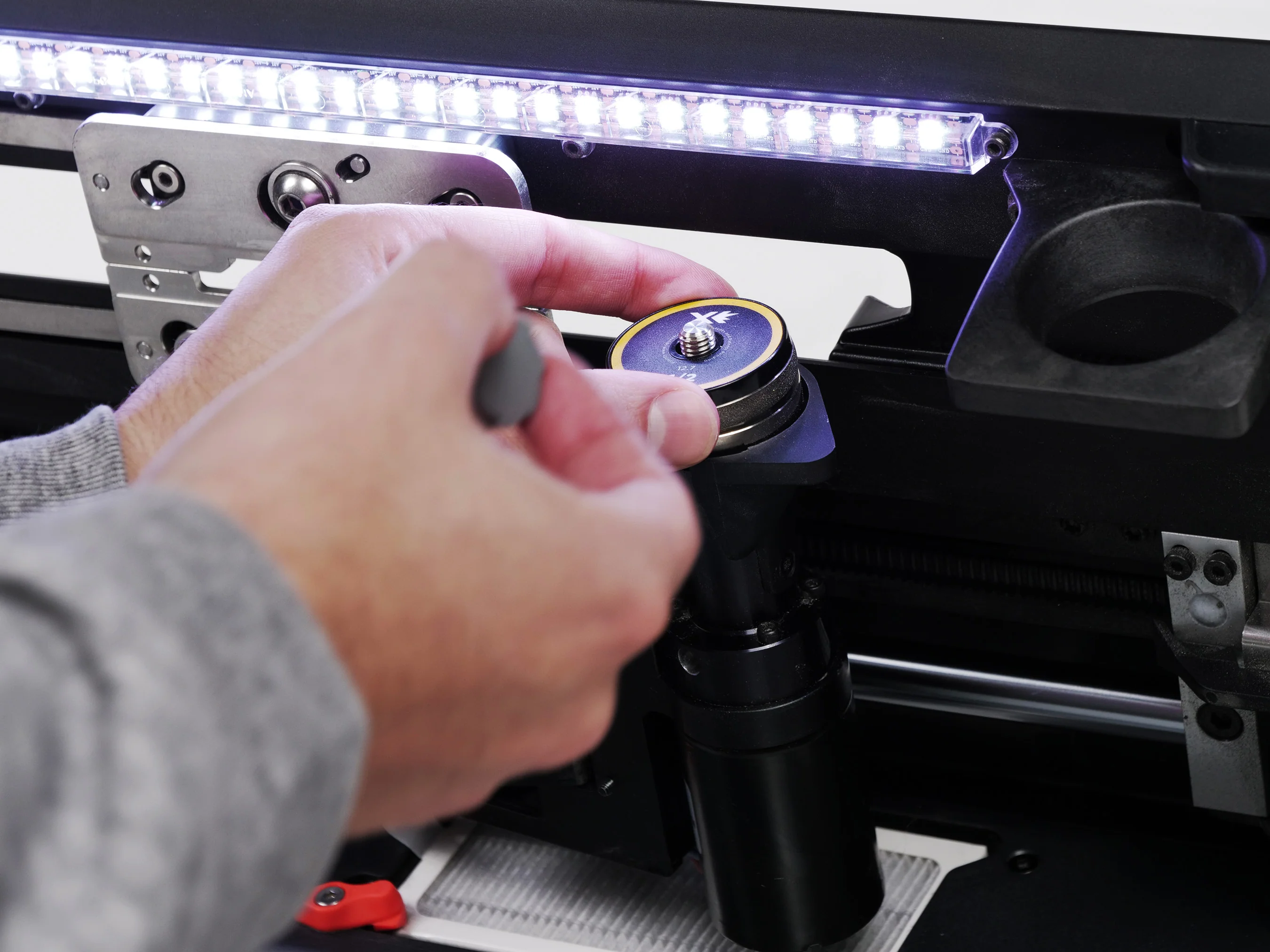 Loading a fresh SPARX grinding ring into the sharpener under the LED light